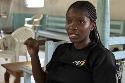 An Easy Group volunteer speaking during a community empowerment and mentorship session in Kibera, Nairobi.